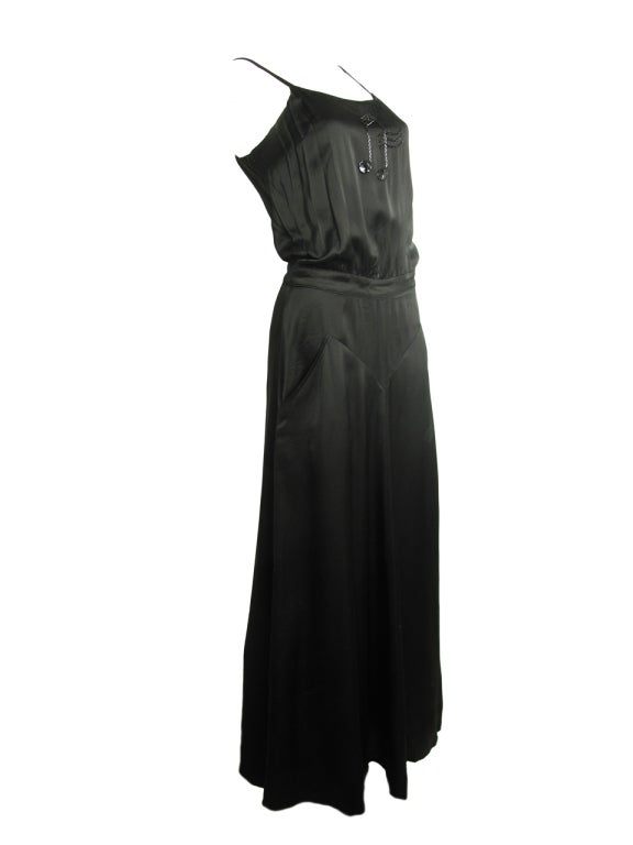 Krizia black dress with musical notes, and pockets.  Condition: Excellent. 
34