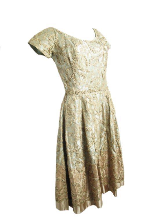 Hattie Carnegie baby blue dress with mauve lace overlayed. Dress is not lined. Condition:  as is, few small discolorated spots in lace and stress tears on shoulders from hanging. 

35