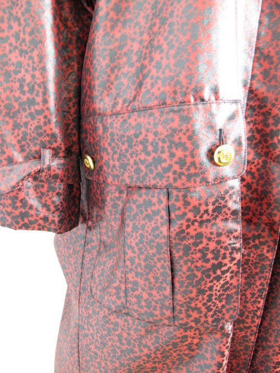 Chanel deep red/ pink and black splatter vinyl raincoat. Fabric lined. Two large front pockets and 