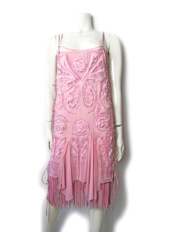 Pink sheer dress with fabric roses with leather lacing up sides and fringe at hem. Net slip underneath. <br />
<br />
Condition:Excellent. <br />
<br />
28