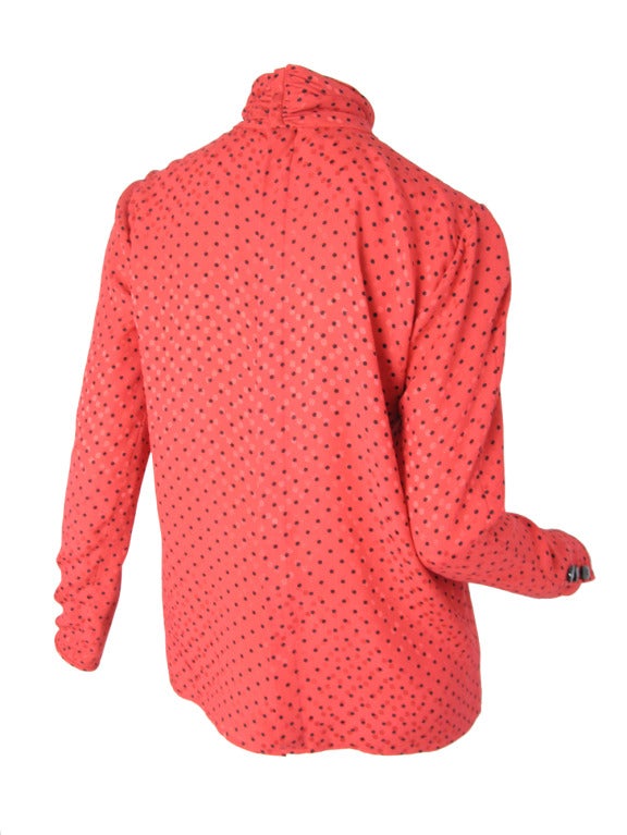 Valentino red silk blouse with black polka dots.  Buttons up back.  Condition: Excellent. 38