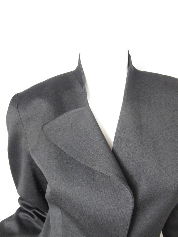 Thierry Mugler black wool blazer with asymmetrical collar and two front pockets.  Snap closure. 35