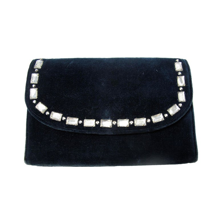 CHANEL dark blue velvet clutch with rhinestones. Age of bag is unknown. It could possibly be from 1930's - early 40's. From the looks of interior construction and size. Some all over wear. Snaps to close.<br />
Stamped CHANEL inside.<br />
<br