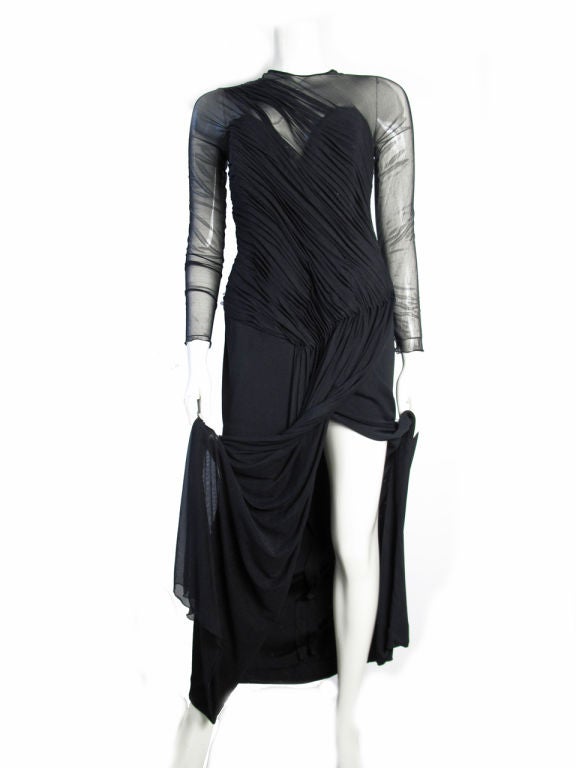 Vicky Tiel Black rayon jersey and net evening gown. 
Boning in bodice, High slit. 

36