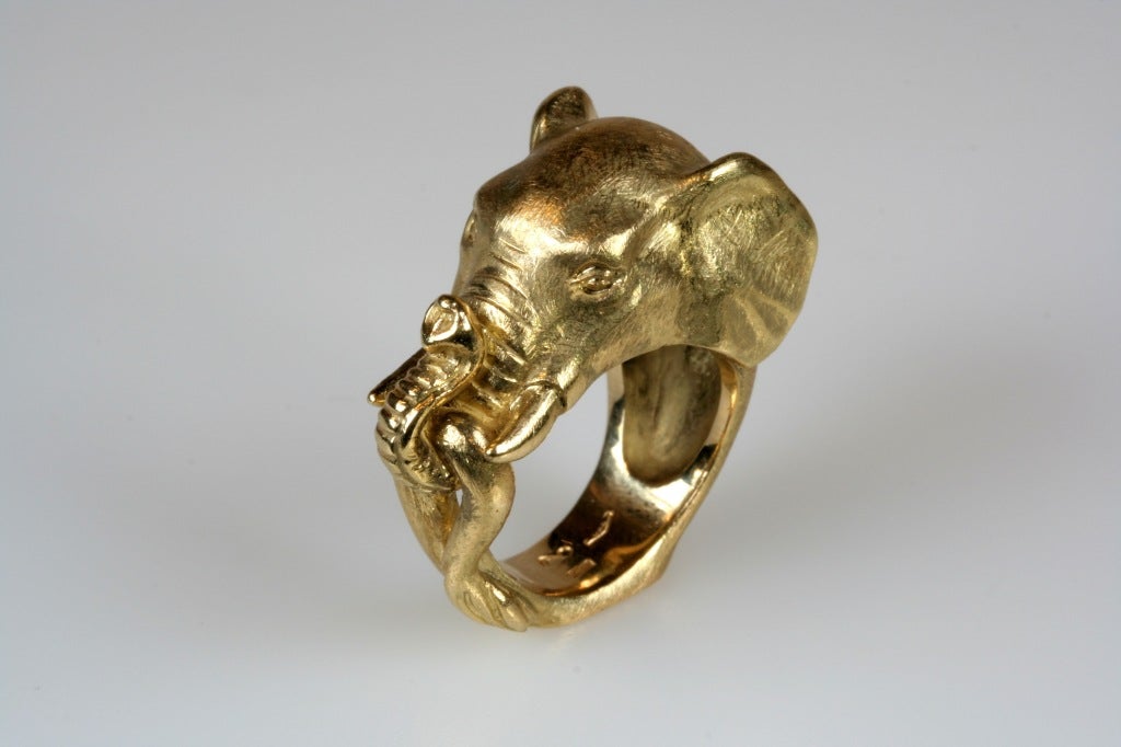 Realistically sculpted 18kt yellow gold elephant ring.  The ring size is an American 5, meant to be worn on the pinky, and resizing is possible.