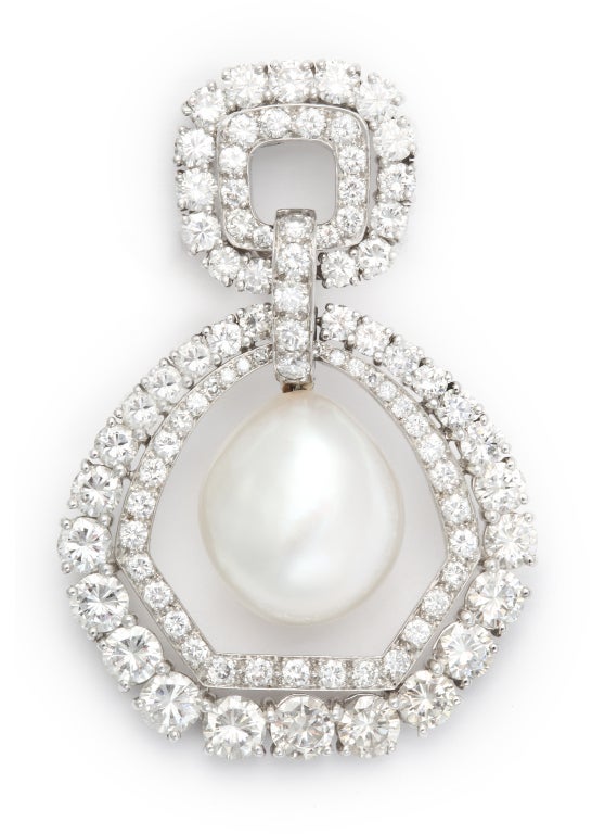 Bold and elegant pearl and diamond earclips.  The impressive baroque pearls are suspended within a double row of the whitest and brightest round diamonds.  Measuring 2 inches long and 1 1/2 inches wide, these wonderful earclips truly exemplify the