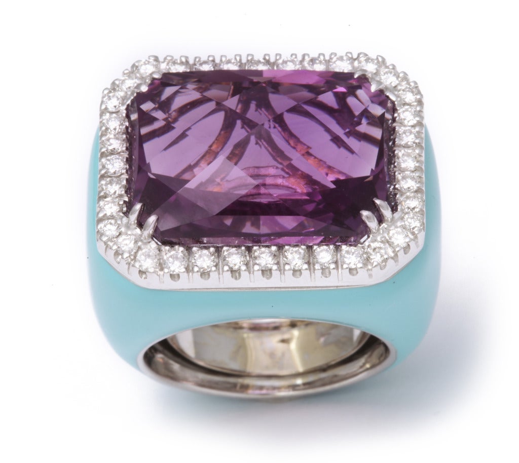 The mounting in this ring is entirely enameled in a beautiful turquoise and set with a bright purple amethyst, framed by diamonds.  This wonderful combination of colors makes a bold and elegant statement.  Size 7.5 with an internal spring for