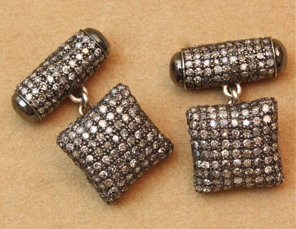 Set with champagne tinted diamonds in blackened silver, these cufflinks whisper, 