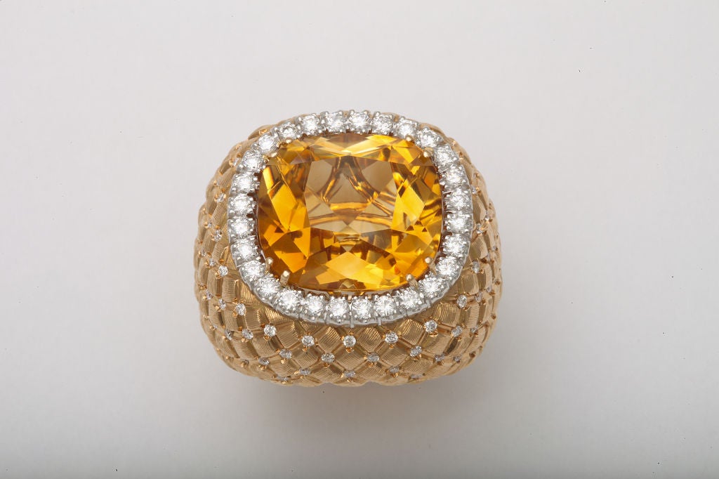 This bold cocktail ring features a bright amber-orange Palmeira citrine weighing 18.73cts.  These stones are considered to be some of the finest citrines and come from the Palmyra mines in Southern Brazil.  The mounting is of a complimentary rose