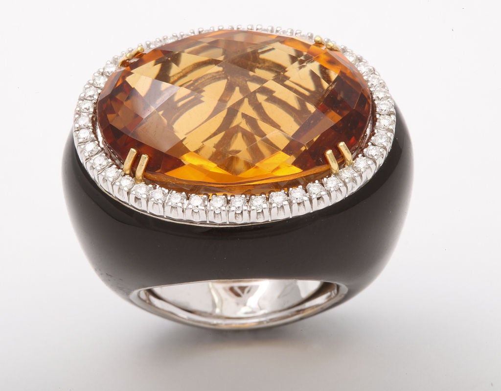 This bold cocktail ring features a rich, orange citrine weighing 31.62cts.  The entire ring is sheathed in shiny black enamel with a frame of round white diamonds.  The vivid color of the stone and the striking design of the ring are sure to be