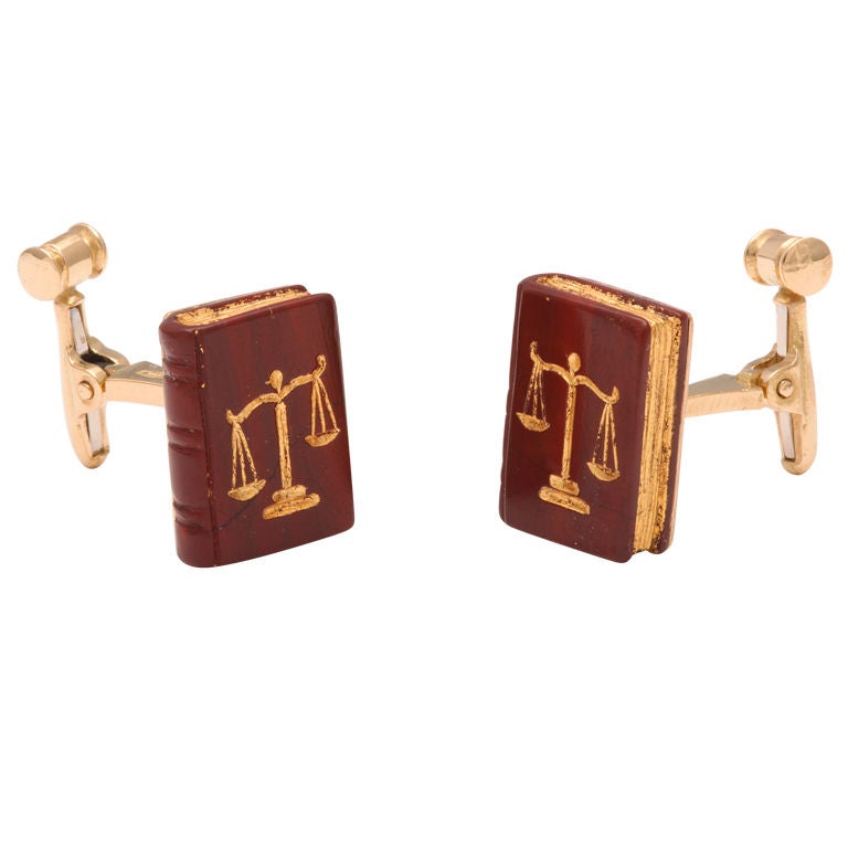 These realistic looking books are carved from natural brown jasper and inlaid with 22kt gold.  The reverse spring is in the form of a judges gavel- perfectly completing the design.  The carvings are done in Germany and the handmade mountings in