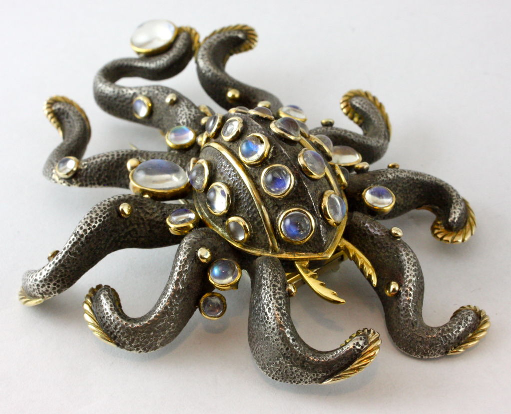 Charming, and wonderfully detailed, this octopus features glowing moonstones set into 18kt yellow gold and patinated silver.  This combination of metals, as well as the original use of moonstones make this piece a true Marilyn Cooperman classic.<br