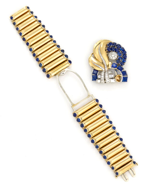 14 karat yellow gold, diamond and sapphire bracelet, with removable center which can be worn as a clip! The bracelet centers a pierced, retro leaf design decorated with cabochon and rectangular sapphires and baguette, single and round brilliant-cut
