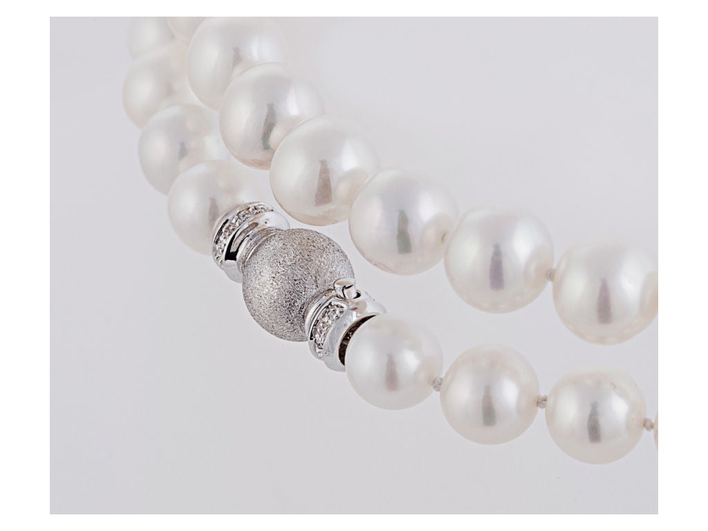 1 strand of 91 fresh water cultured pearls, 35 inches long,9.0 - 10.0 mm, white color with rose overtone, excellent luster and clean surfaces, completed by an 18 karat white gold clasp bead-set with 12 small round diamonds, total weight