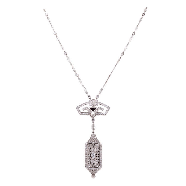 Beautiful pendant watch and chain, done in intricately pierced geometric designs and bead and bezel-set with 225 single-cut, old European-cut, Transitional-cut, marquise-shaped, rose-cut and round brilliant-cut diamonds. Color: F-G, Clarity: