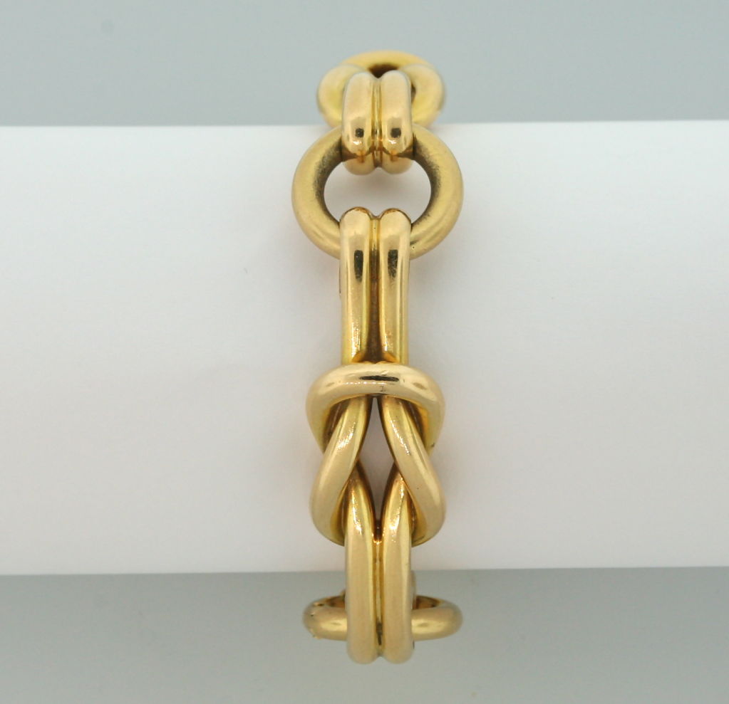 An 18 karat yellow gold link bracelet, designed as a series of slip knots.