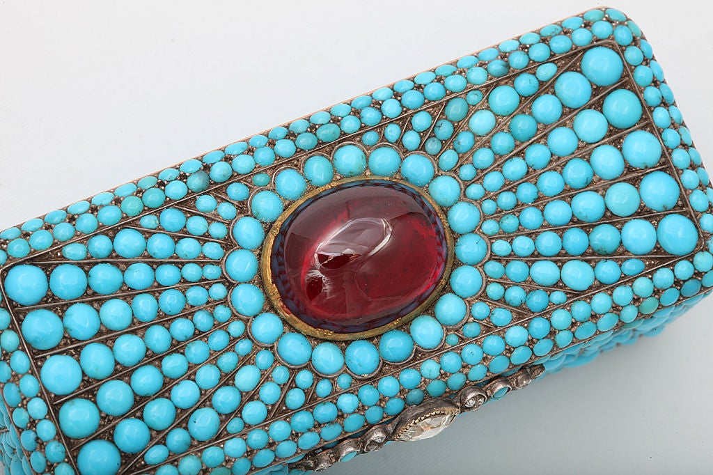 Fine and Rare Russian oblong gem-set gold snuff box. <br />
<br />
Attributed to Karl C. Barbe, circa 1810. 7.5cm long. <br />
<br />
Incrusted all sides with cabochon turquoises forming floral patterns, the cover with a cabochon garnet;