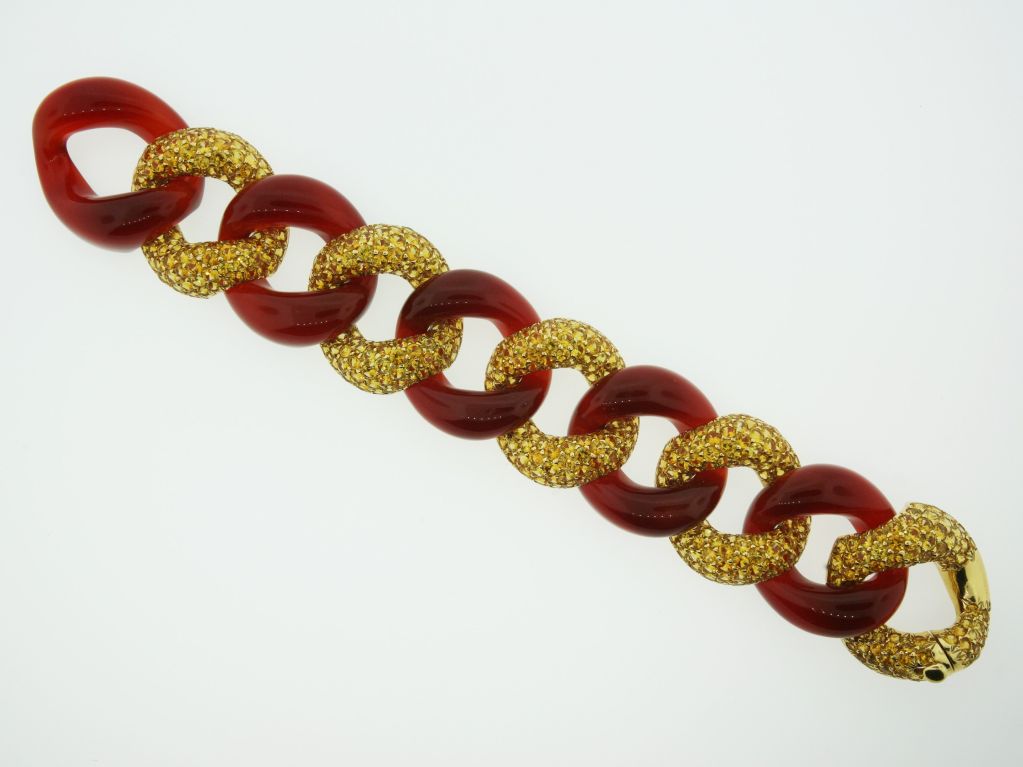 A bracelet of alternating carnelian and round cut yellow sapphires set in 18 karat yellow gold.