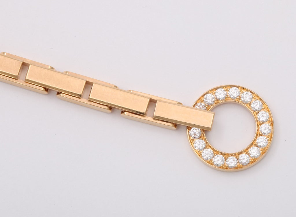 A bracelet in 18 karat yellow gold in the typical Cartier brick link design with diamond detail in the buckle.