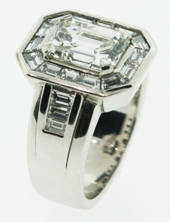 An 18 karat white gold engagement ring set with a rectangular Asscher cut at the center weighing 2.41 carats, I color, VVS clarity, with baguette cut diamonds in the shank on either side and at the bezel.  Ring Size : 7