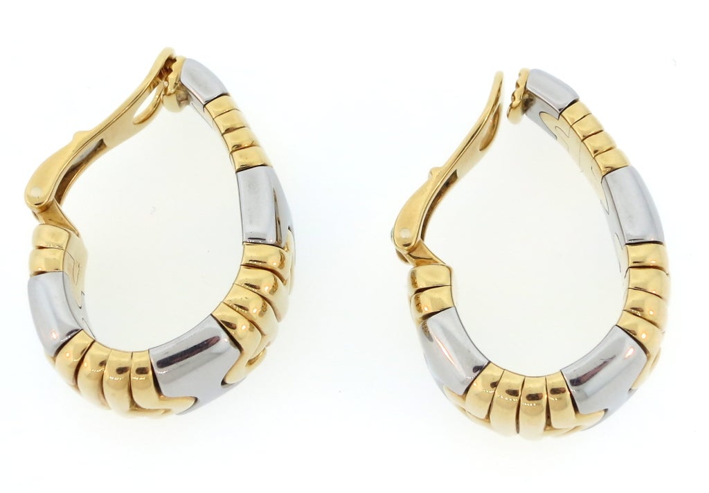 A pair of 18 karat yellow gold and steel 