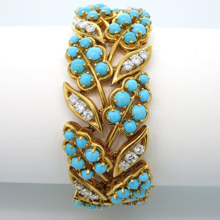 An 18 karat yellow gold bracelet of floral design, set with diamonds and cabochon persian turquoise beads.