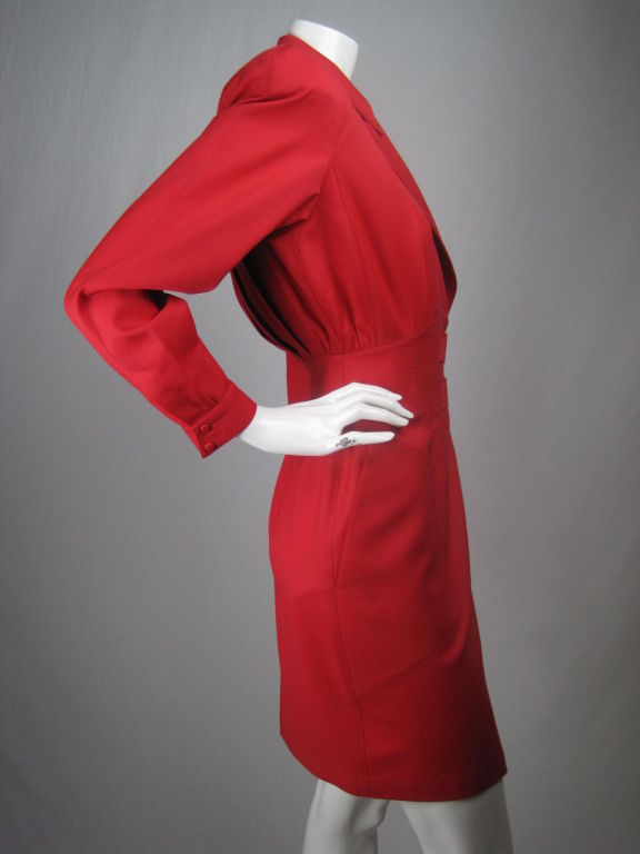 MARKED DOWN FROM $495!

Red-orange dress from Thierry Mugler.  Wrap-style with double belted closures at waist.  V-neck with two piece notch lapel that snaps into one piece.  Long sleeves with double snap cuff.  Side front patch pockets. 