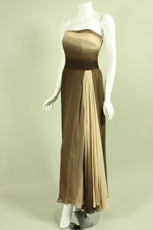 Vintage tea-length gown dates to the 1950's and is made of brown ombre chiffon.  Pleated boned bodice.  Full skirt has side waist fabric insert that is cut on the bias and creates a dramatic effect.  Fully lined.  Side metal zipper.  This gown is