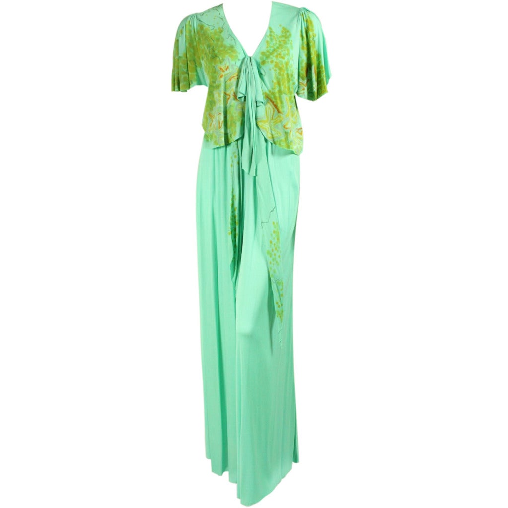 Vintage ensemble from iconic 1970's American designer Holly's Harp is made of mint green matte jersey.  Blouse and sash feature a floral and leaf pattern that was hand-painted onto the fabric.  Blouse has a v-neck, short sleeves that are gathered at