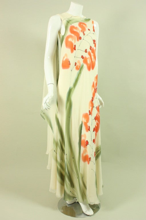 Vintage gown from Greek-American designer Stavropoulos dates to the 1970's and retailed at Elizabeth Arden.  It is made of layers of bias-cut cream colored silk chiffon that is hand-painted to depict an abstracted floral print.  It is sleeveless and