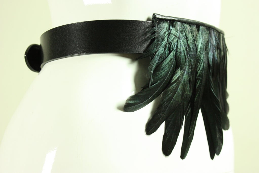 Contemporary belt from Martin Margiela is made of black leather with an iridescent grouping of rooster feathers that can be shifted anywhere on the belt.  Adjustable silver-toned closure is hidden when the belt is being worn.

Length: 26 1/2- 33