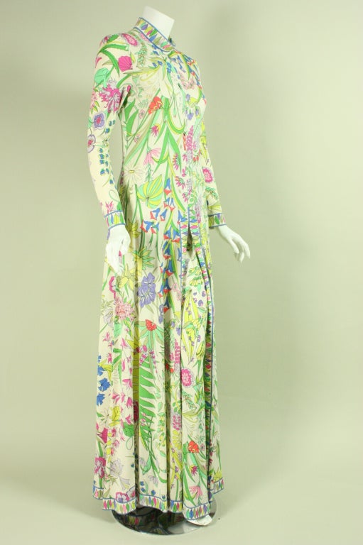 Vintage two-piece ensemble from Bessi is made of white silk jersey with a multicolored floral print and consists of a long, floor-length tunic and pants.  The tunic, which can double as a dress has a round neck, long tapered sleeves, a center front