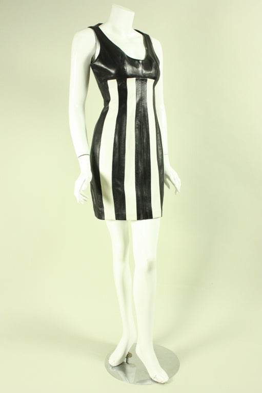 Vintage dress from Michael Hoban for North Beach Leather dates to 1991 (as identified by an interior tag) and is made of buttery soft leather.  Black bodice has a deep scoop neckline.  Body of dress is comprised of vertical stripes of black and