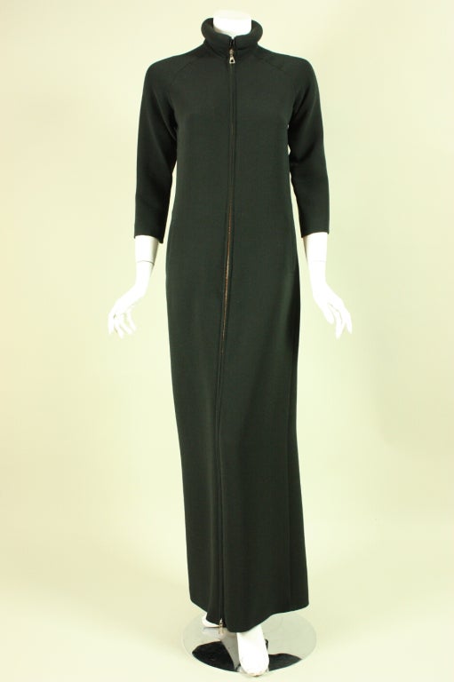 1990’s jumpsuit by Jean-Paul Gaultier is made of black gabardine.  It features a padded magnetic collar that closes at the center front.  The front of the jumpsuit has a zipper at the so that the neckline can be unzipped as low as you want.  Center