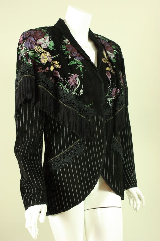 Vintage jacket by Roberto Cavalli dates to the 1980's and is made of black suede.  Hand-painted yoke has fringed edges.  Slant pockets.  Center front snap closure.  Lined.  Padded shoulders.

Labeled size Small.