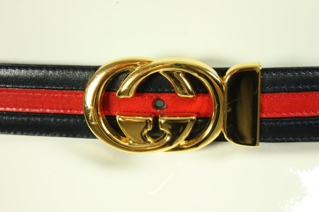 Vintage belt by Gucci with the original box dates to the 1970's and is made of navy and red leather.  Gold-toned buckle featuring interlocking G's.  Like new condition.