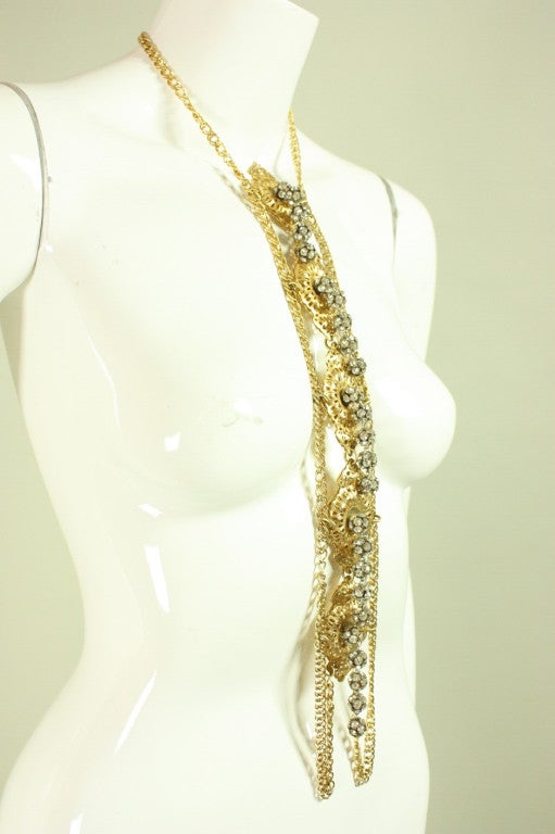 Vintage body jewelry dates to the 1960's through 1970's.  It is made of gold-toned filigree metal with clear rhinestone dangles.  Unknown maker.

Measurements-
Overall Length: 22