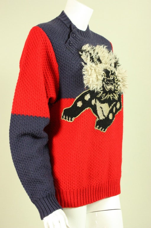 Fun sweater from Kansai Yamamoto is made of red and navy textured wool blend and depicts a Komainu (Chinese lion dog) with a three-dimensional mane.  Round neck.  Three button closure at side neck.  Unlined.

93% Wool, 4% Metallic Yarn, 3%