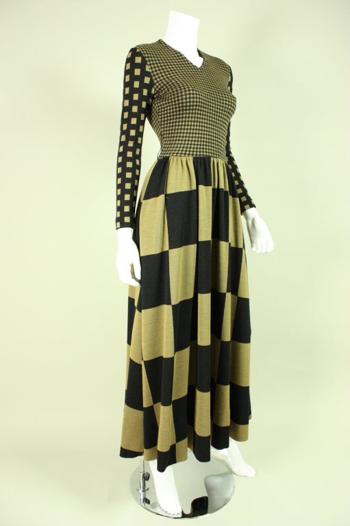 Vintage maxi dress from iconic designer Rudi Gernreich dates to the early 1970's and is made of stretch wool.  Op-art check print of varying sizes in black and light brown.  Fitted bodice has high v-neck and long tapered sleeves.  Full-length skirt