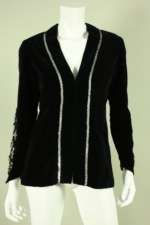 Vintage jacket from Thea Porter Couture dates to the 1970's and is made of the softest jet black velvet.  Sequin and beaded detail on sleeves run approximately from the elbows to the wrists.  Center front hook and eye closures.  Zippered cuffs. 
