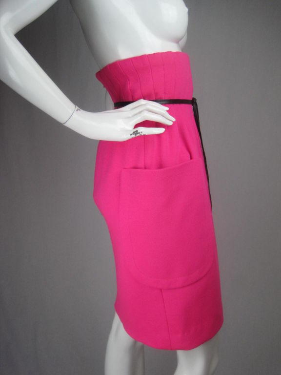 MARKED DOWN FROM $1150!

Hot pink knit skirt from Pierre Cardin.  Pleated high waist.  Large side patch pocket.  Narrow leather black belt with fringed tassels.  Above knee-length.  Lined throughout waist area.  Center back invisible zipper.
No