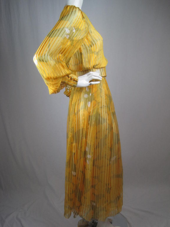 Late 1970's through early 1980's custom made, full-length dress from Beverly Hills designer Leon Paule.  Yellow silk chiffon with self-woven stripe has allover abstract print.  Working covered buttons down center front.  Billowing sleeves have long