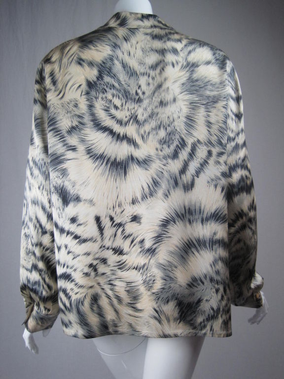 Beige silk blouse with highly detailed fur print in black, gray, white, and silver.  Button front.  V-neck with notch lapel.  Long sleeves with single button cuff.  Side bust darts.  Pearlized buttons have gold trim.  Unlined.<br />
Labeled size