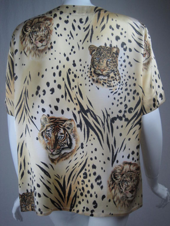 Silk charmeuse in varying tones of yellow, gold, and white and printed with lion, tiger, and jaguar faces.  Three gold-toned, textured buttons on each shoulder.  Short sleeves. Round neck.  Unlined.<br />
Labeled size 42.<br />
<br