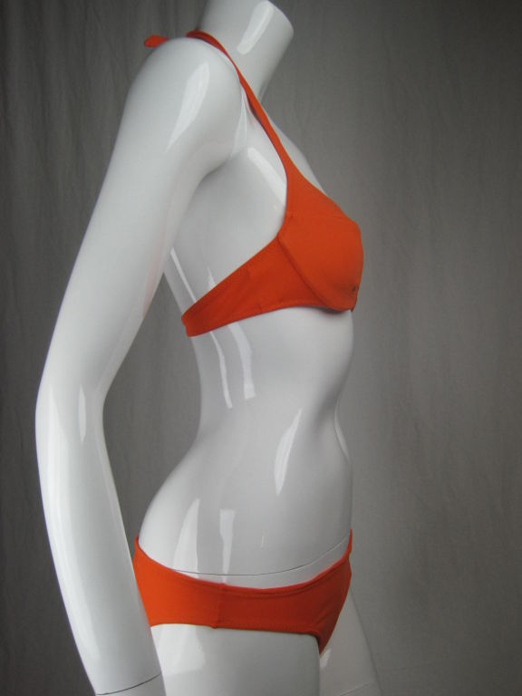 La Perla tangerine-colored bikini.  Top has halter-style tie neck.  Interesting cut out detail at center front.  Plastic clasp at center back.  Bottoms are low rise and have full back.  <br />
<br />
Labeled Italian size 42, which is French 38 and