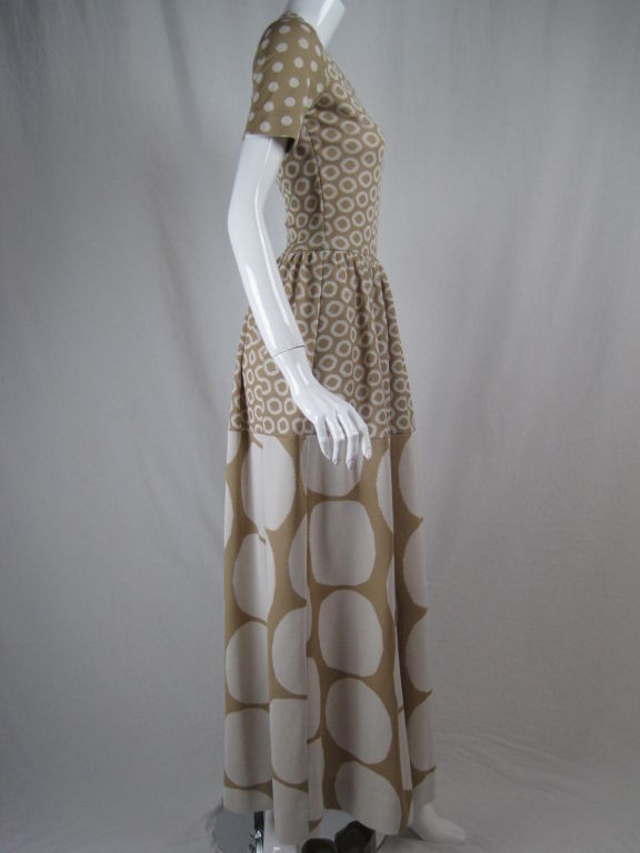Rudi Gernreich full-length dress.  Graphic knit features varying sizes of white and tan polka dots.  Full skirt is gathered at waist.  Scoop neck.  Short sleeves.  Fitted bodice.  Center back zipper.  Unlined.

Labeled size