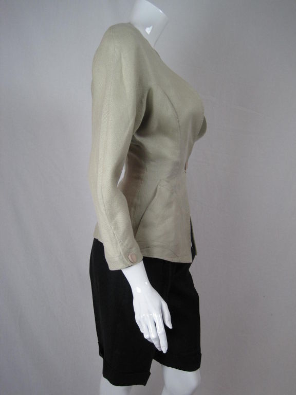 MARKED DOWN FROM $450!

Summer ensemble from Thierry Mugler.  Single breasted blazer has exaggerated hourglass shape through large shoulder pads and nipped waist.  Blazer has patch pockets, snap closure, and 3/4-length sleeves.  Shorts have