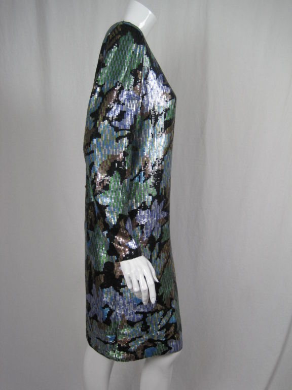 Oscar De La Renta shift-style dress covered entirely with small sequins.  Black ground with leaves in shades of purple, blue, green, and brown.  Round neck.  Long sleeves with zip cuff.  Fully lined.  Center back zip.  Shoulder pads.

Labeled size