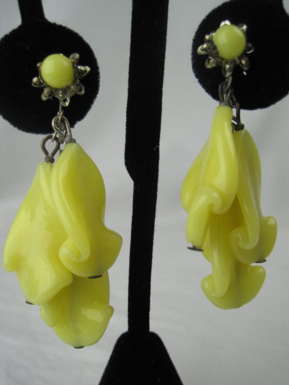 Glass pendant earrings from Miriam Haskell.  Milky yellow opaque shaped glass.  Silver-toned hardware.  Screw back.

Measurements-

Overall length: 2 3/8