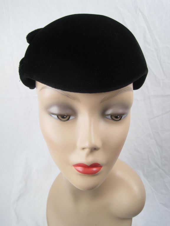 Black felt cocktail hat.  Black glass seed beads concentrically hand-sewn.  Unlined.<br />
<br />
Measurements-<br />
Height: 5